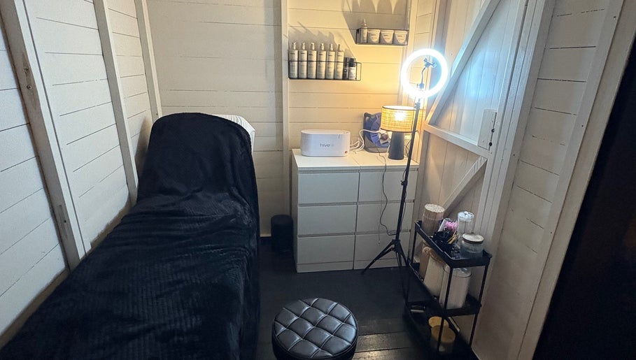 Beauty By Ells treatment room in Riddings, England, featuring a serene bed and modern equipment.