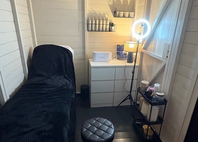 Beauty By Ells treatment room in Riddings, England, featuring a serene bed and modern equipment.