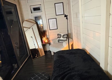 Cozy relaxation corner at Beauty By Ells, Riddings, England, GB, featuring a plush chair and soft lighting.