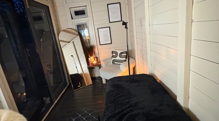 Cozy relaxation corner at Beauty By Ells, Riddings, England, GB, featuring a plush chair and soft lighting.