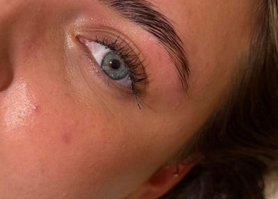 Close-up of well-groomed eyebrow at Beauty By Ells, Riddings, England, GB showcasing flawless skin and care.