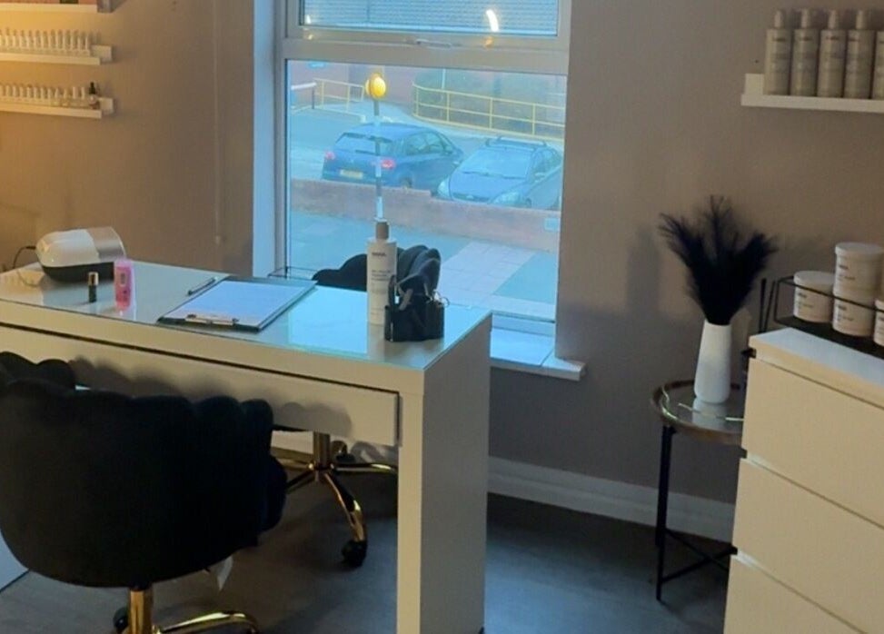 BeautyByElls salon in Ilkeston, England, showcasing a stylish nail station and modern decor.