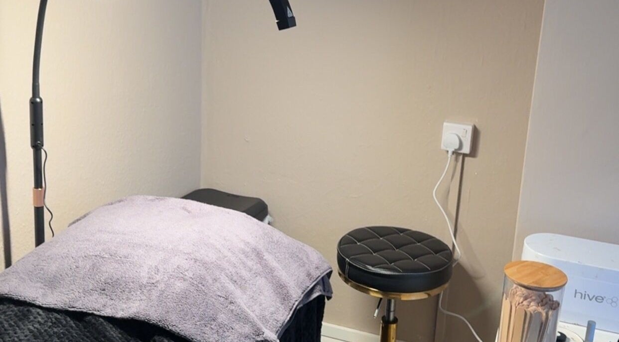 BeautyByElls private treatment nook in Ilkeston, England with a plush bed and stool.