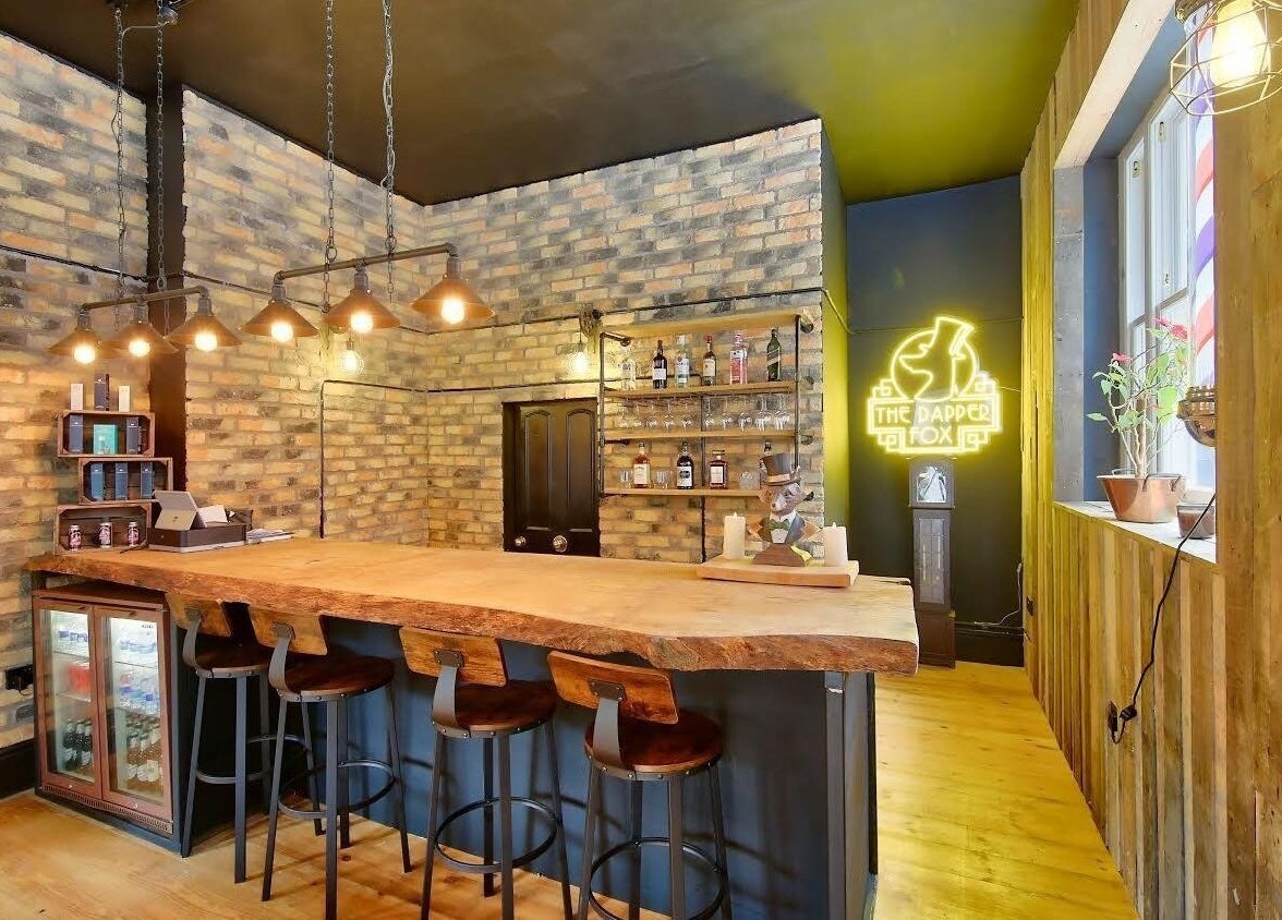 Cozy bar interior at The Dapper Fox - Wandsworth, London, England, GB. Wooden furniture and ambient lighting.
