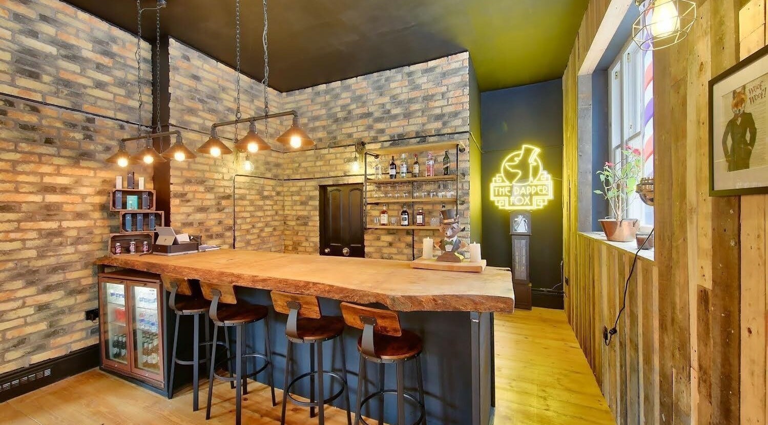 Cozy bar interior at The Dapper Fox - Wandsworth, London, England, GB. Wooden furniture and ambient lighting.