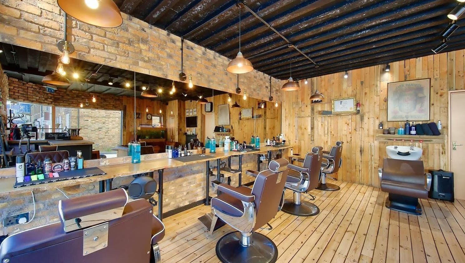 Interior of The Dapper Fox - Hampton Wick, a rustic barbershop in Hampton Wick, England, GB with wooden decor.