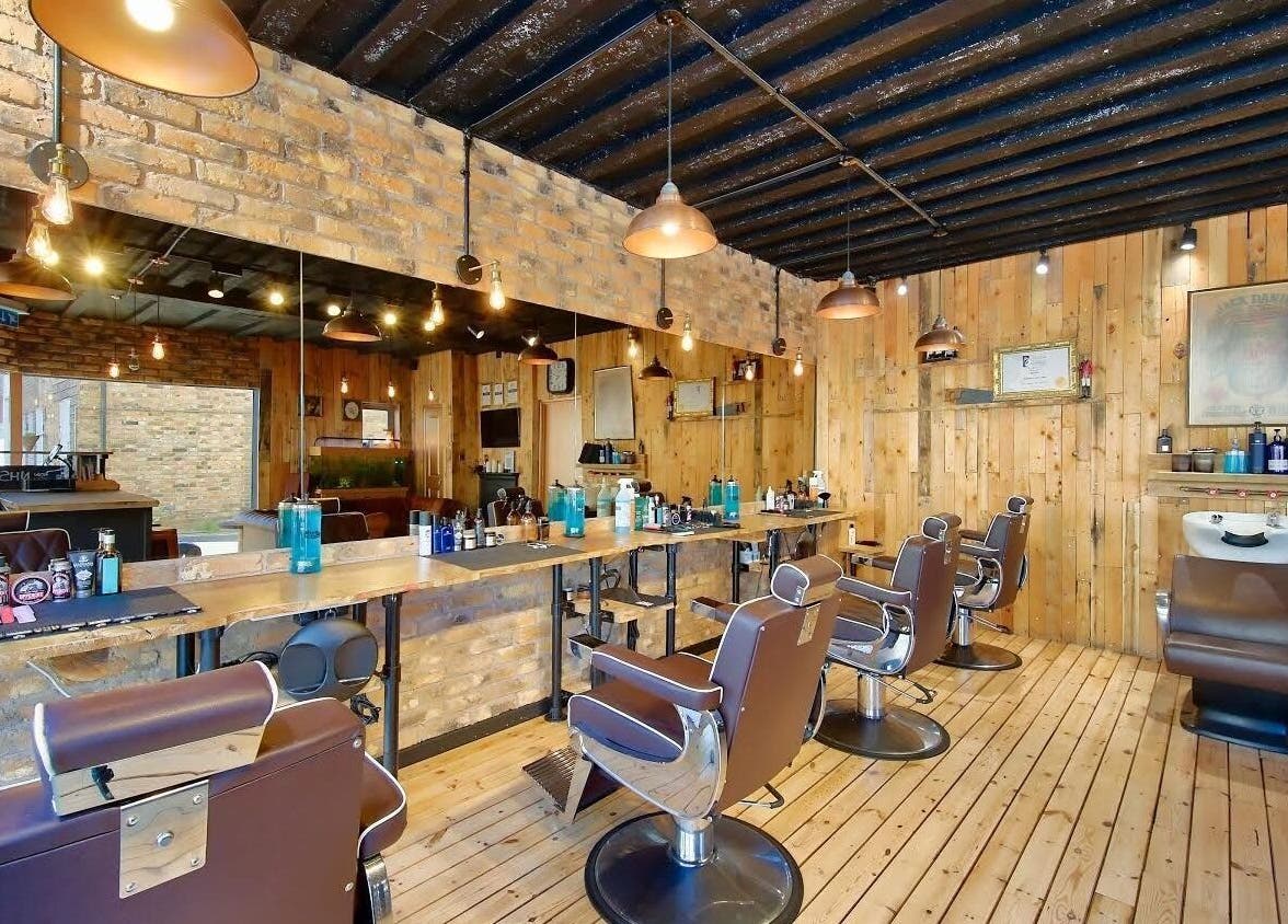 Interior of The Dapper Fox - Hampton Wick, a rustic barbershop in Hampton Wick, England, GB with wooden decor.