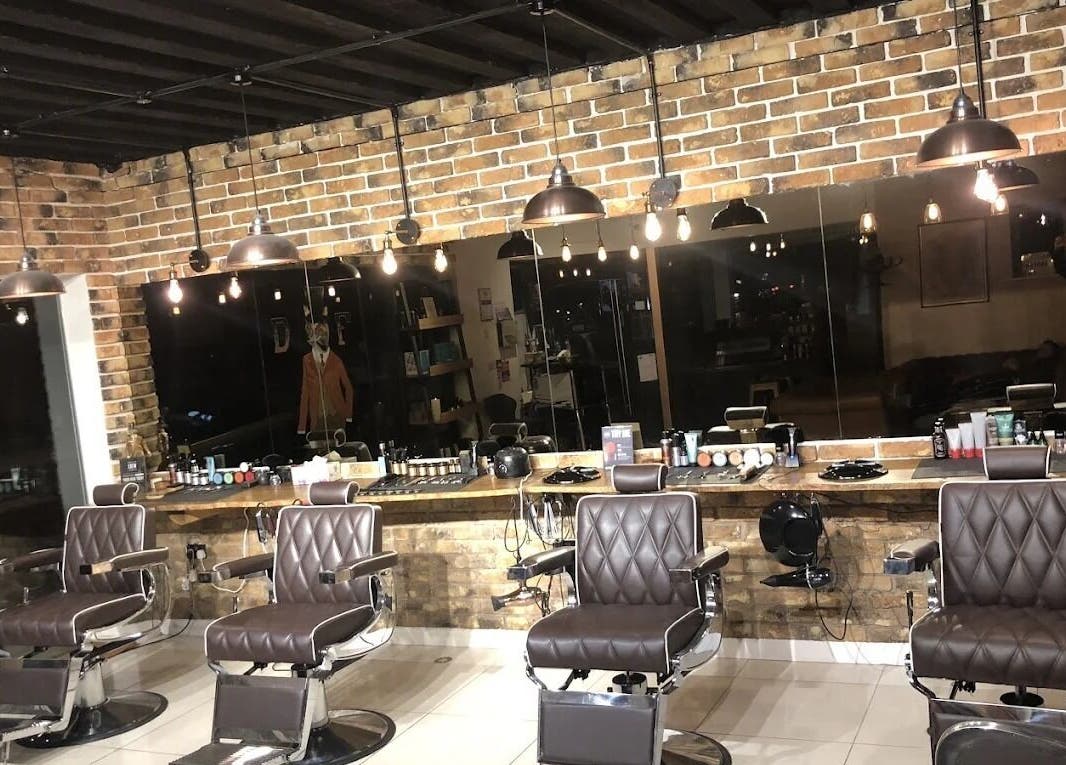 Sleek barber chairs at The Dapper Fox - Hampton Wick, Hampton Wick, England, GB in a stylish, rustic setting.