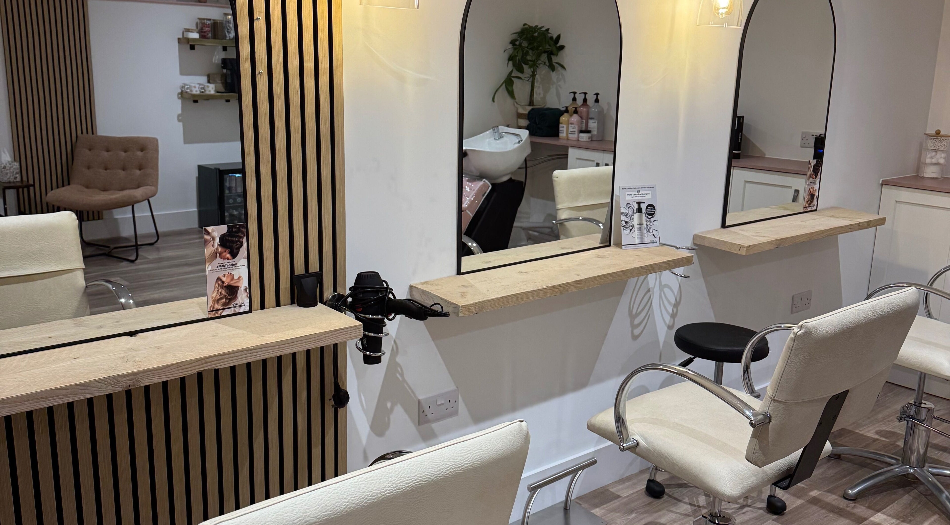 Modern styling station at The Lair Studio in Bridgwater, England, GB with sleek chairs and mirrors.