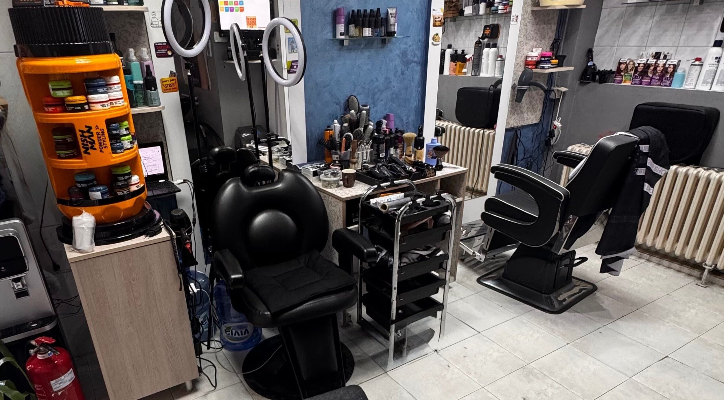 Interior of Frizerski Salon Friki 021 in Novi Sad, Vojvodina, RS, showcasing modern styling stations.