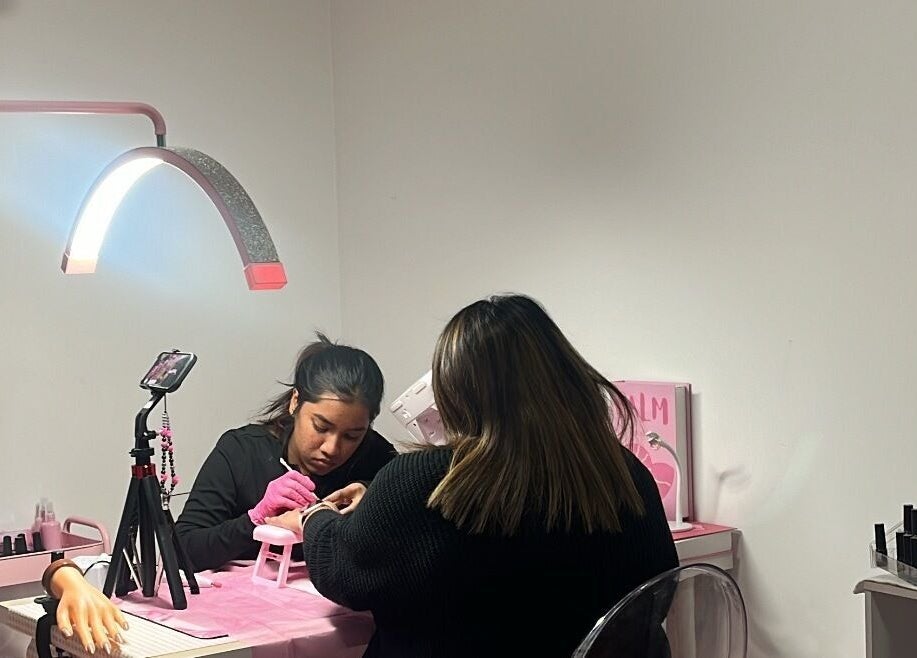 A nail technician performing a manicure at Beckyy’s Glam Atelier, Modbury North, South Australia, AU.