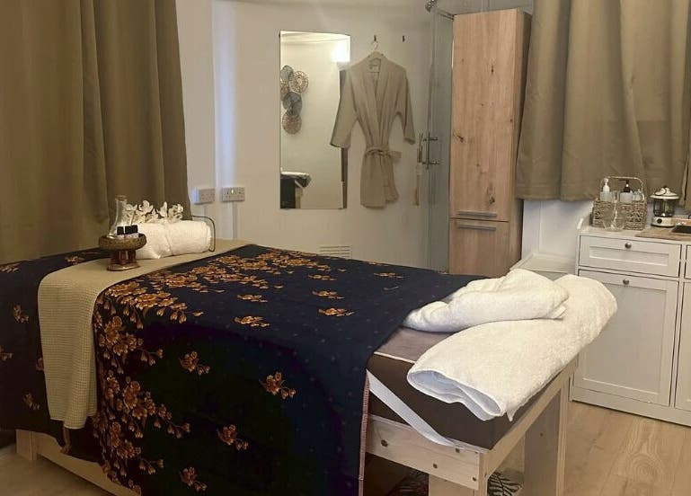 Relaxing massage room at Suk Jai Richmond Thai Massage, Richmond, England, GB with cozy decor and plush linens.