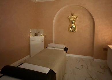 Luxurious massage room at The Calm Lab, Conisbrough, England, GB, with candles and elegant decor.