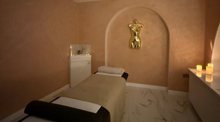 Luxurious massage room at The Calm Lab, Conisbrough, England, GB, with candles and elegant decor.
