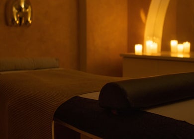 Tranquil massage room at The Calm Lab, Conisbrough, England, GB, softly lit with candles.
