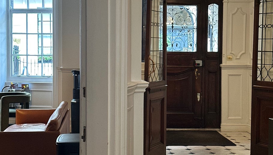 Elegant entrance area at Christina Bethany, London, England, GB showcasing classic wooden doors and bright interior.