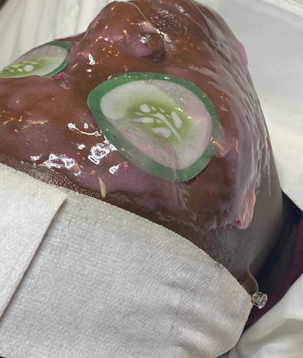 Relaxing facial treatment at Pampered Skin Oasis, Nassau. Cucumber slices on a calming mask enhance relaxation.