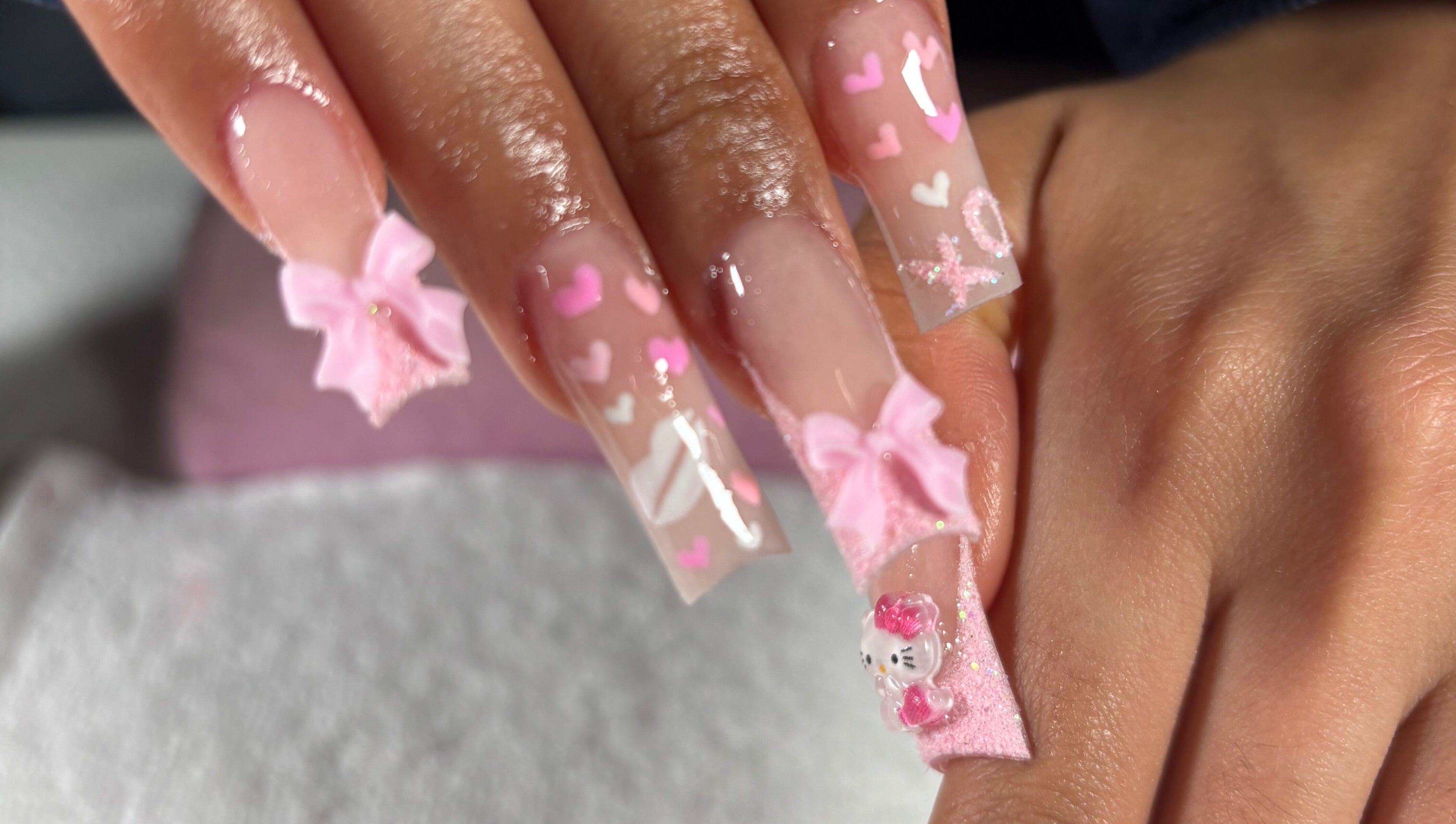 Elegant pink nail art with bows and hearts at Nailsbymsgirl in Brampton, Ontario, CA.