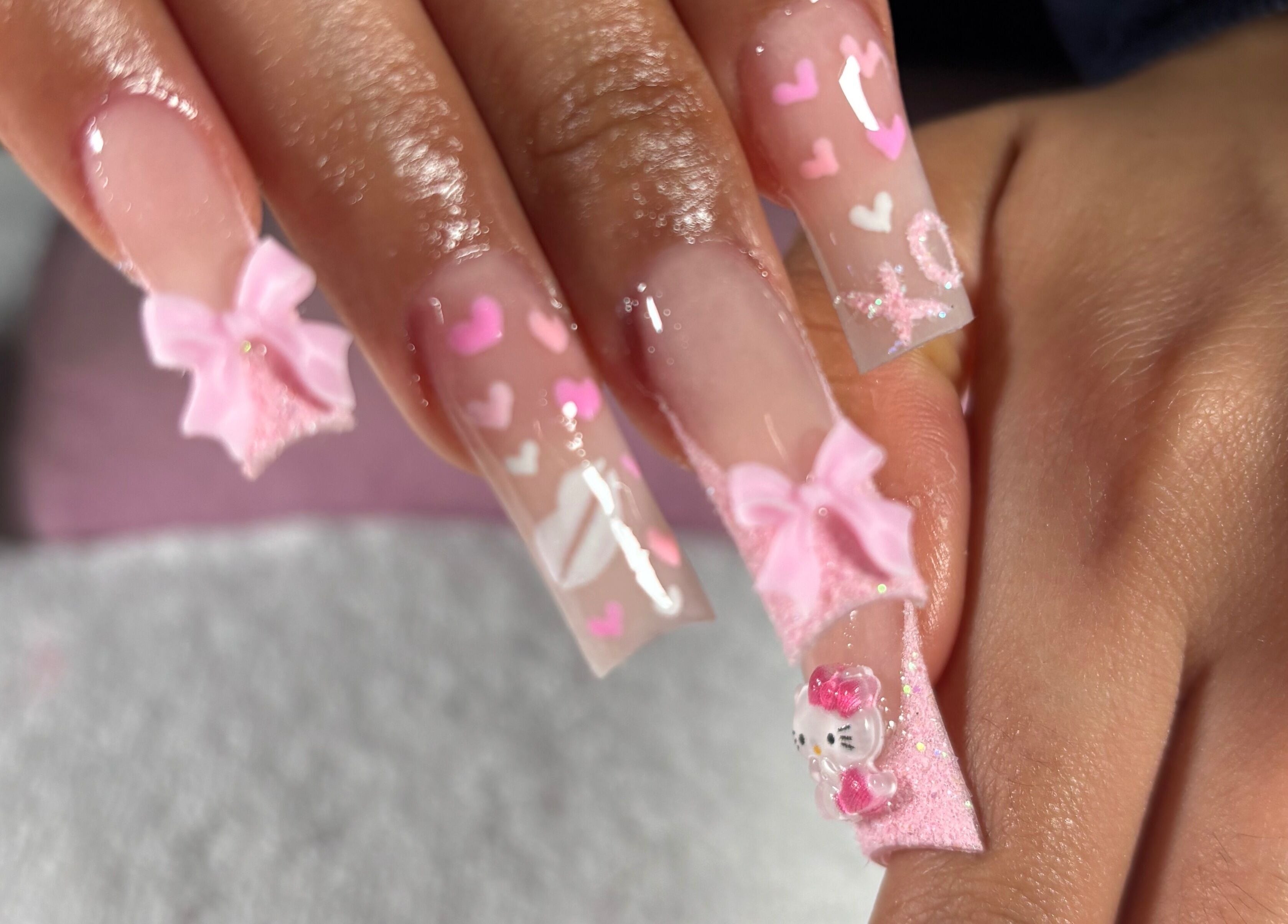 Elegant pink nail art with bows and hearts at Nailsbymsgirl in Brampton, Ontario, CA.