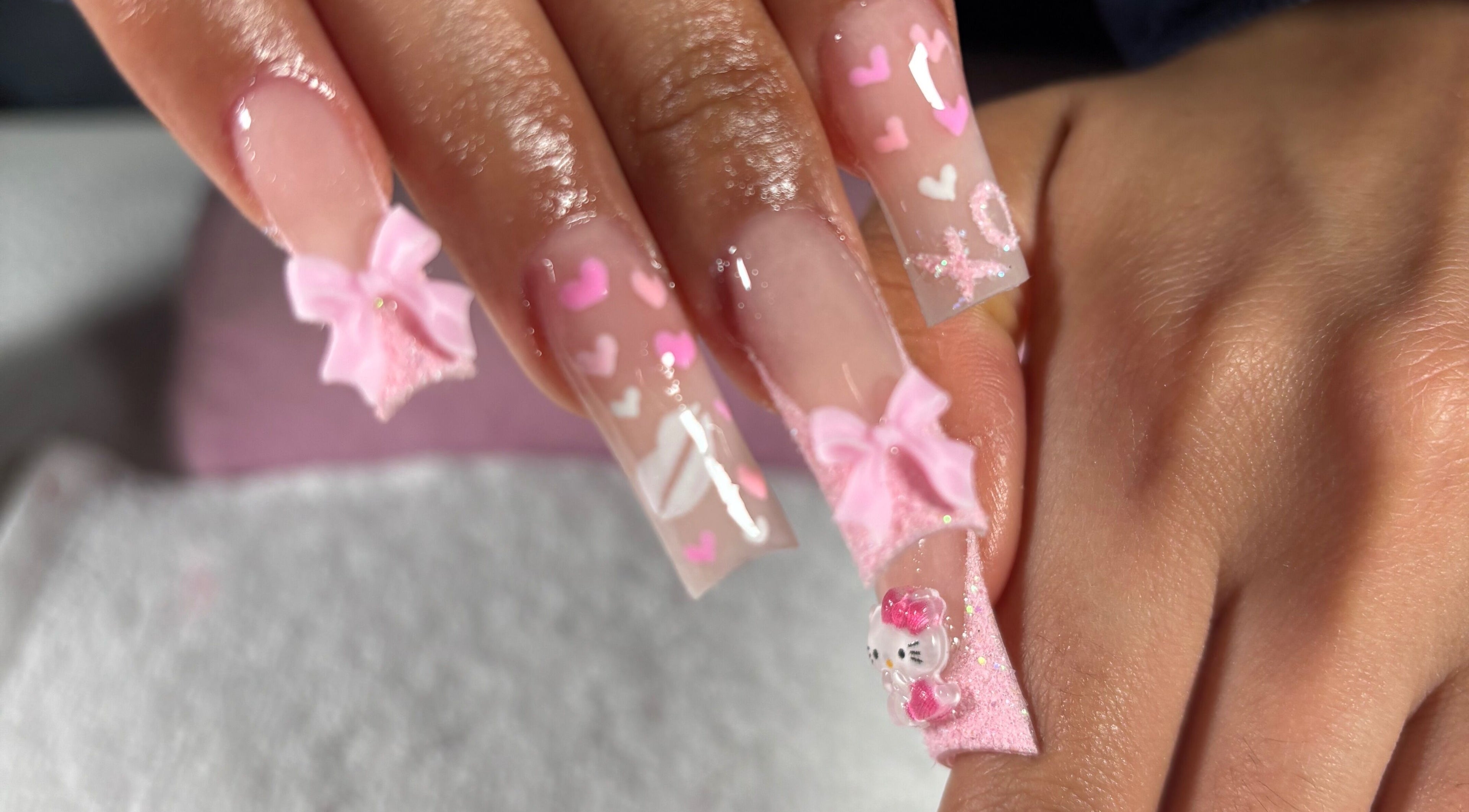 Elegant pink nail art with bows and hearts at Nailsbymsgirl in Brampton, Ontario, CA.