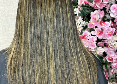 Gorgeous straight hair at VIPA GREEN NAIL BAR & SPA, Santo Domingo, DO, complemented by vibrant pink blossoms.