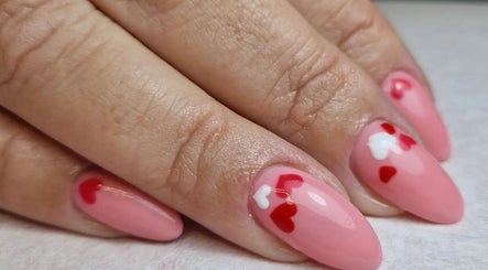 Pink nails with red and white heart designs at Beauty & Nails by Agnes, Bangor, Northern Ireland, GB.
