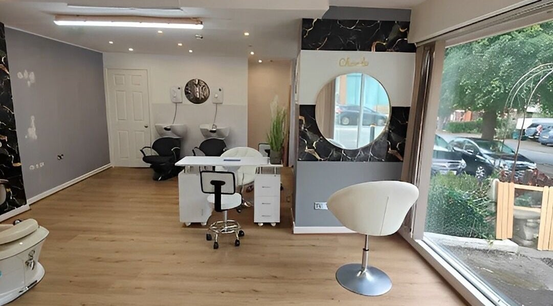 Chic interior of Chandu Hair & Beauty, Colwyn Bay, Wales, GB, featuring styling chairs and large mirrors.