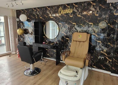 Elegant salon interior at Chandu Hair & Beauty, Colwyn Bay, Wales, GB with chic decor and styling stations.