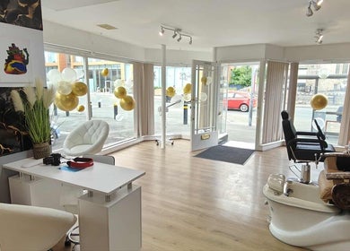 Bright, modern interior of Chandu Hair & Beauty salon in Colwyn Bay, Wales, GB with luxurious seating and decor.