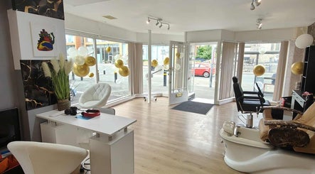 Bright, modern interior of Chandu Hair & Beauty salon in Colwyn Bay, Wales, GB with luxurious seating and decor.