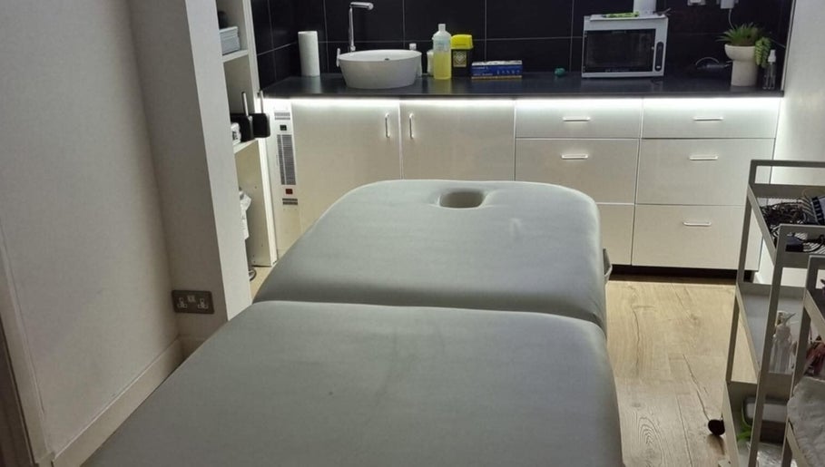 Tranquil spa treatment room at LCH BEAUTY, Dalkeith, Scotland, GB with a massage table and modern amenities.