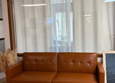 Warm leather sofa in Yadior Beauty, Southfield, Michigan, US, with chic decor and welcoming ambiance.