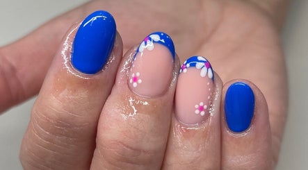 Bright blue nails with floral designs by Perfections Nails and Beauty, Winsford, England, GB.