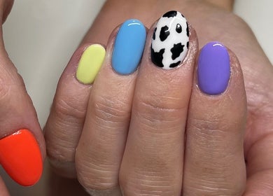 Vibrant manicure at Perfections Nails and Beauty, Winsford, England, GB with multicolored nail art.