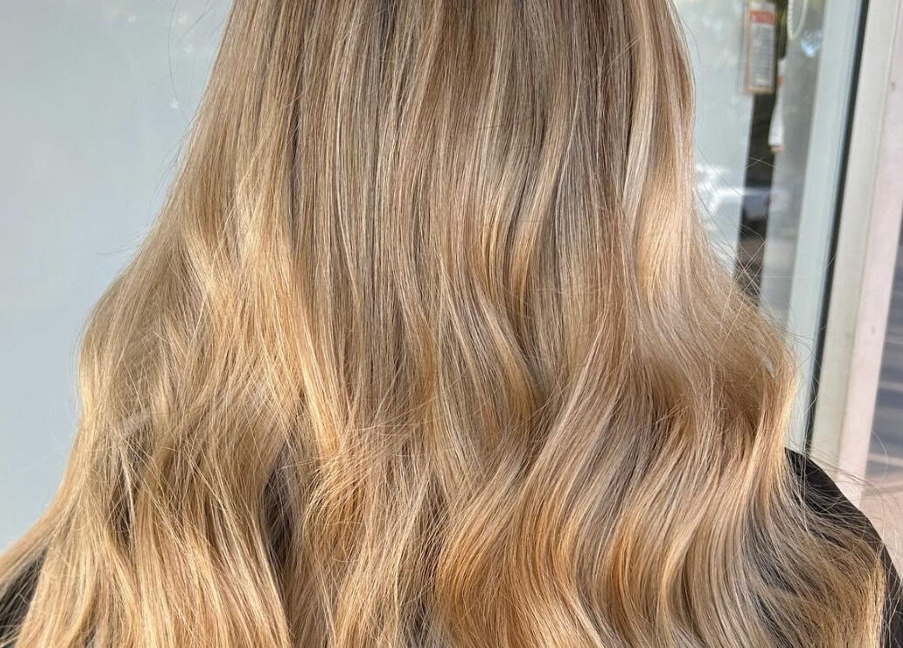 Blonde wavy hair styled at Hair Divine Studio, Mount Isa, Queensland, AU showcasing radiant color and shine.