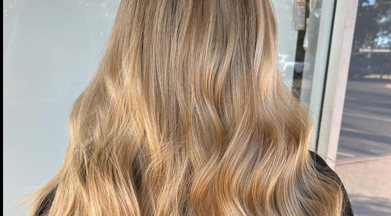 Blonde wavy hair styled at Hair Divine Studio, Mount Isa, Queensland, AU showcasing radiant color and shine.