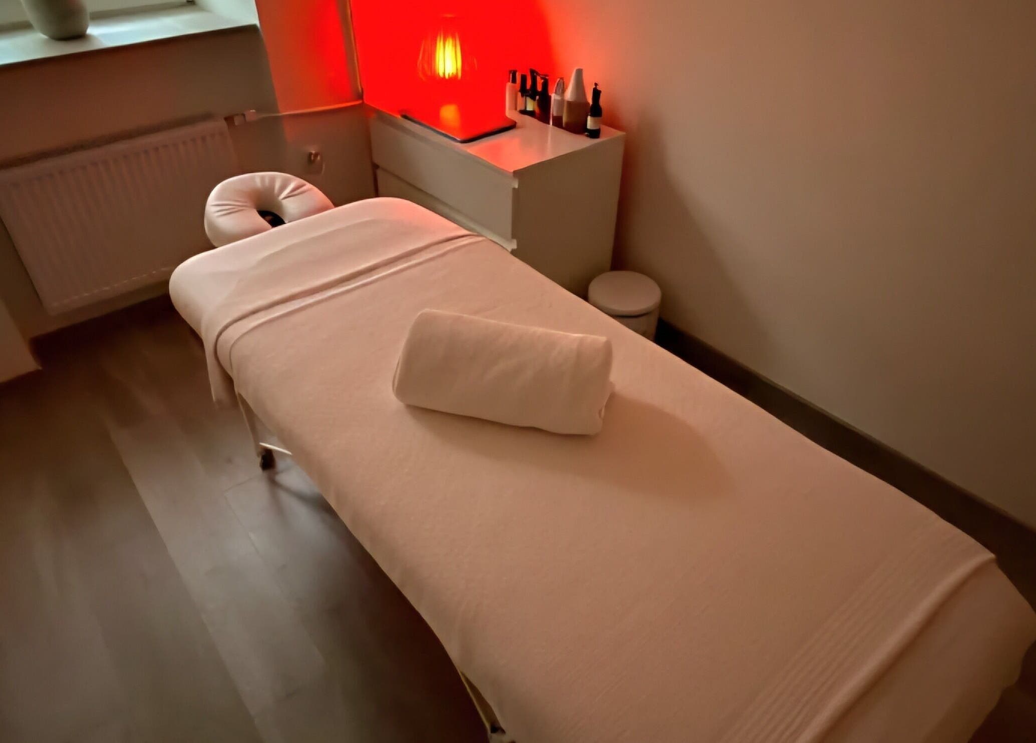 Relaxing massage room at The Room, Melbourne, Victoria, AU with ambient lighting and cozy massage bed.