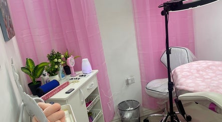 Inviting beauty treatment room at Pro Belle Co in Kingston, New York, US with pink decor and lush greenery.