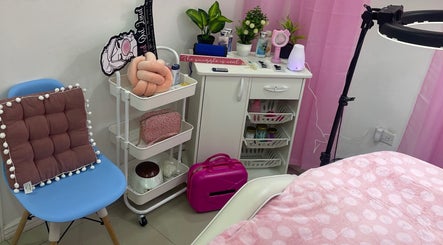 Pro Belle Co's cozy beauty room in Kingston, New York, US, features a relaxing chair, pink accents, and ambient lighting.