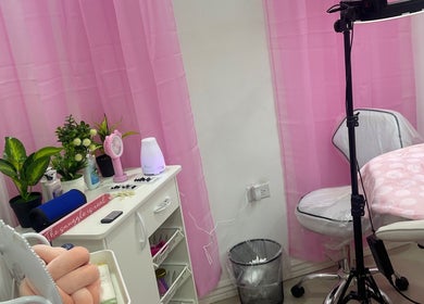 Cozy treatment room at Pro Belle Co, Kingston, New York, US with pink curtains and comfy chair.