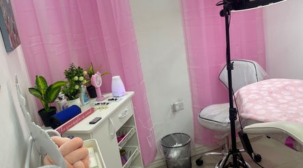 Cozy treatment room at Pro Belle Co, Kingston, New York, US with pink curtains and comfy chair.