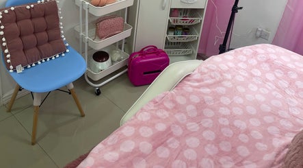 Cozy treatment room at Pro Belle Co in Kingston, New York, US, showing a pink-themed relaxing setup.