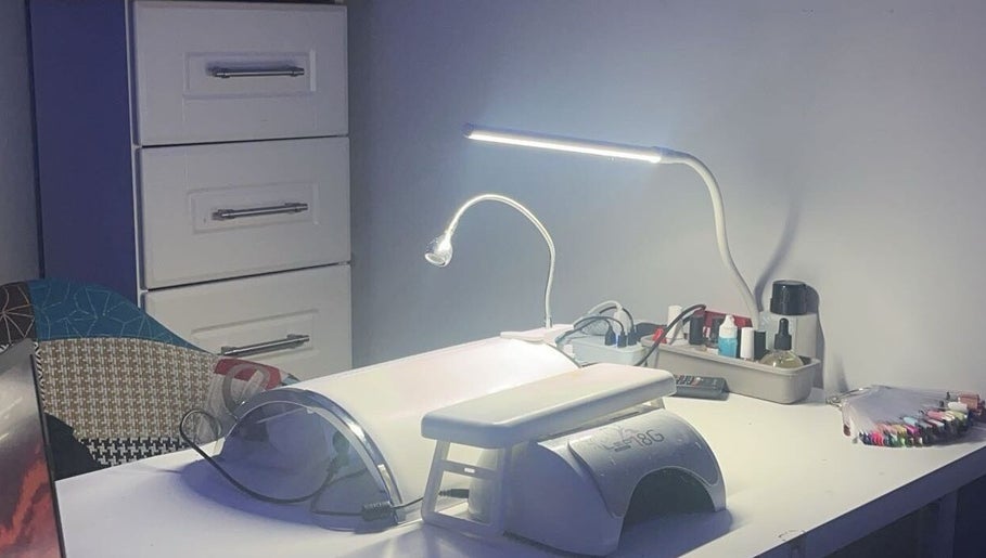 Modern nail station at Nailssbybeccax in County Mayo, IE with manicure tools and LED lamp.