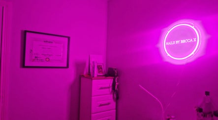Nailssbybeccax venue in County Mayo, IE with vibrant pink neon lighting decor accentuating the salon ambiance.