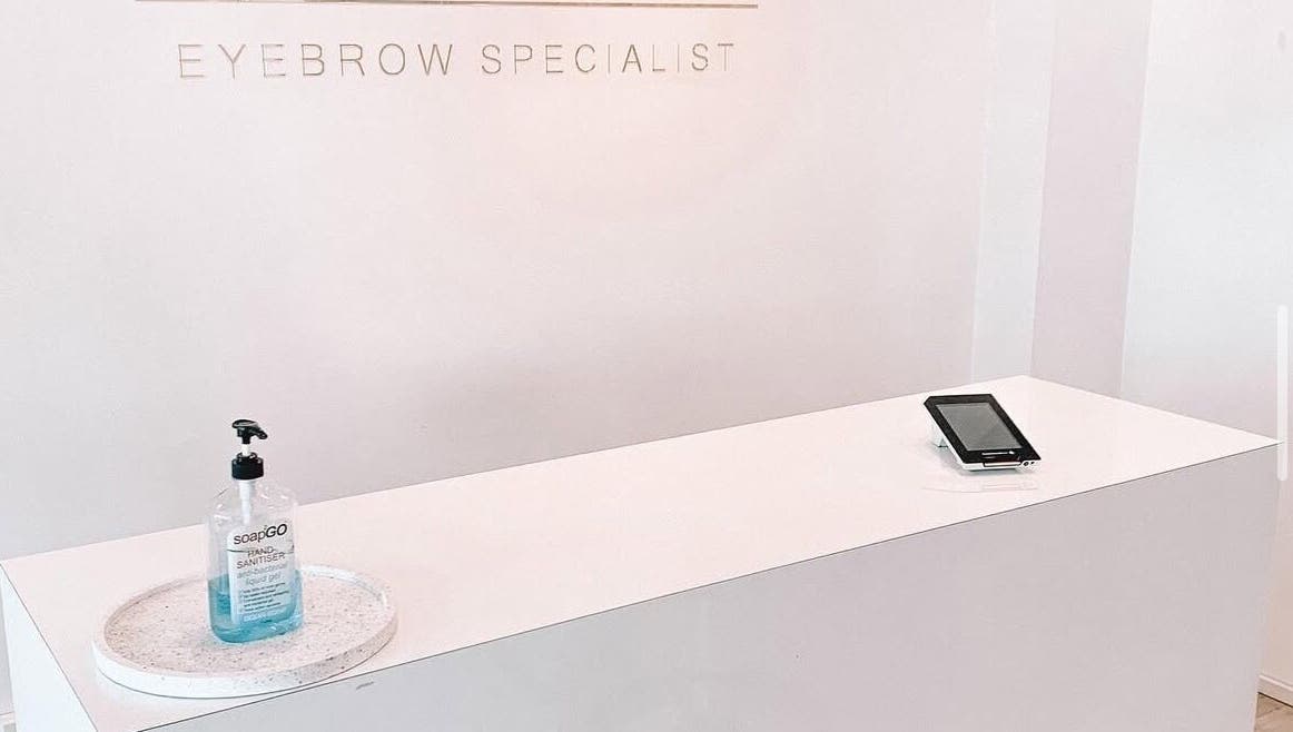 Reception desk at Nails by Fallon in Rose Bay, NSW with sanitizer and tablet.