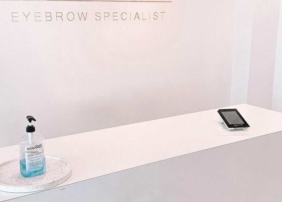 Reception desk at Nails by Fallon in Rose Bay, NSW with sanitizer and tablet.