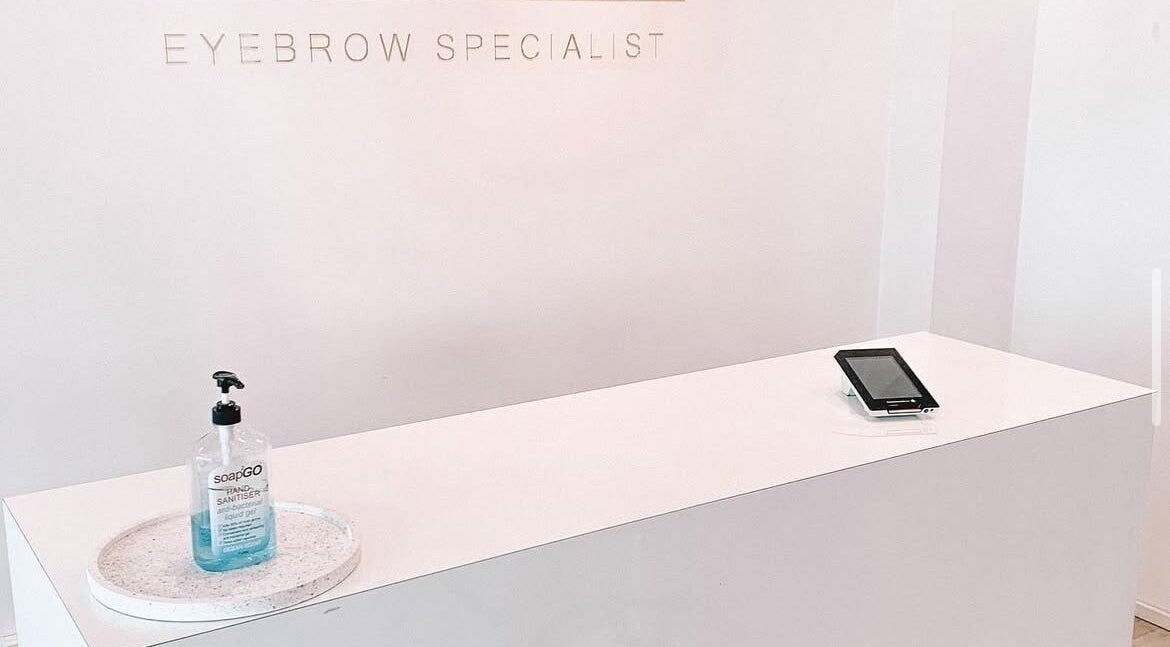 Reception desk at Nails by Fallon in Rose Bay, NSW with sanitizer and tablet.
