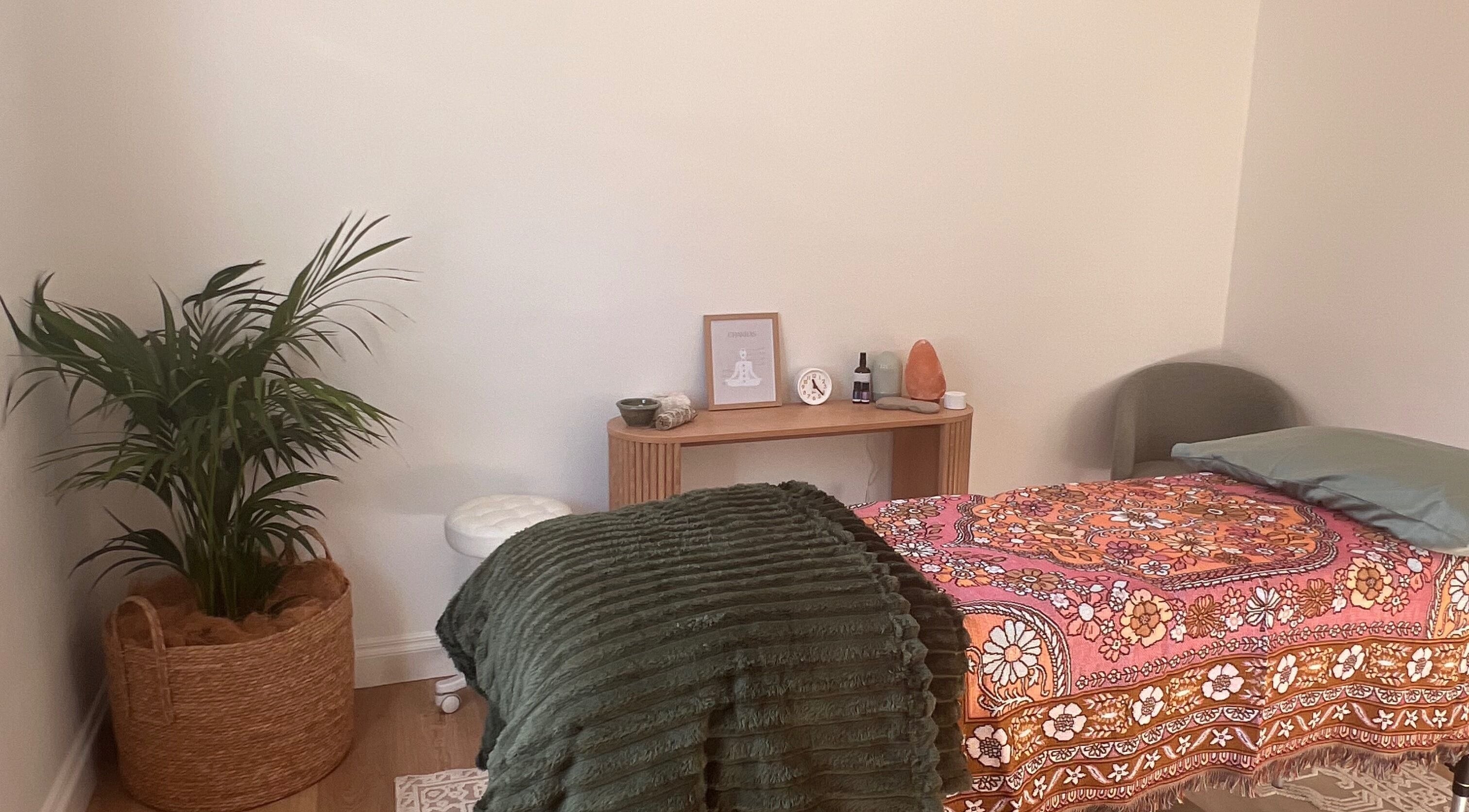 Recharge Reiki Studio room with a cozy bed, plants, and decor in Glengowrie, South Australia, AU.