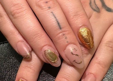 Stylish gold nail art at Manifested Nails in Port Jervis, New York, US.