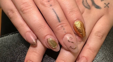 Stylish gold nail art at Manifested Nails in Port Jervis, New York, US.